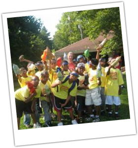 Youth Engineering and Science summer camp participants celebrating outdoors