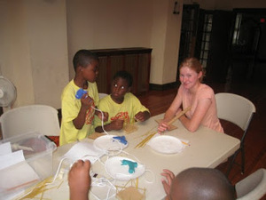 Students and a teacher doing a hands-on experiment around a table