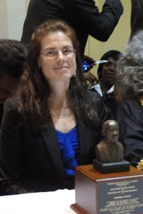 A YES leader beside the Drum Major Award presented by the Philadelphia MLK Jr. Association for Nonviolence