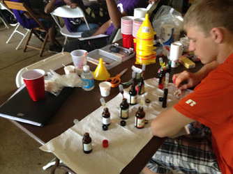 An intern leading a lotions-and-potions chemistry station