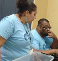 YES mentors in blue shirts supporting students during a program